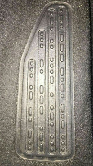 mystery photo of a Jeep foot rest with Morse code words in raised dots and dashes