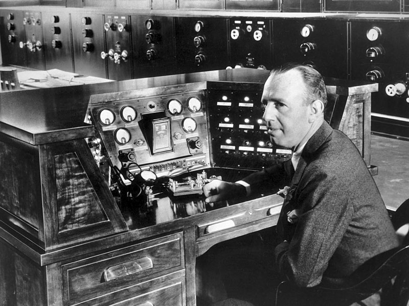 Powel Crosley Jr, young radio magnate, is shown at the control console of his new 500,000-watt transmitter, WLW.