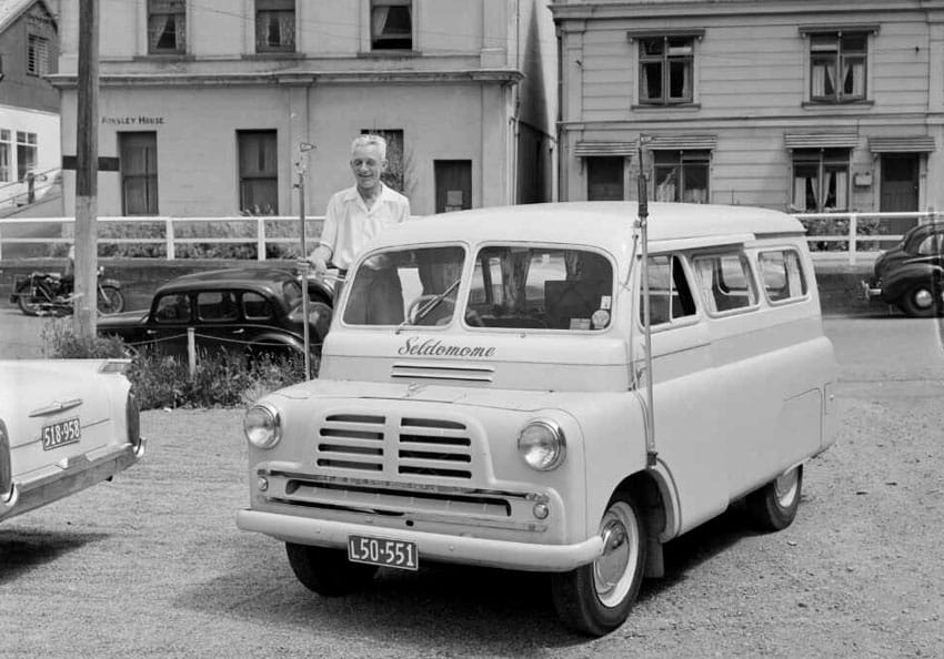 Mr Ashford ZL2RO standing beside his Bedford van with amateur radio antennas in 1960