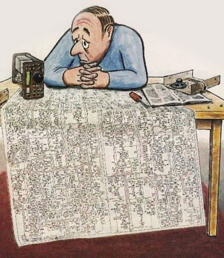 Cartoon shows sad man peering into a modern transceiver with enormous schematic spread on table