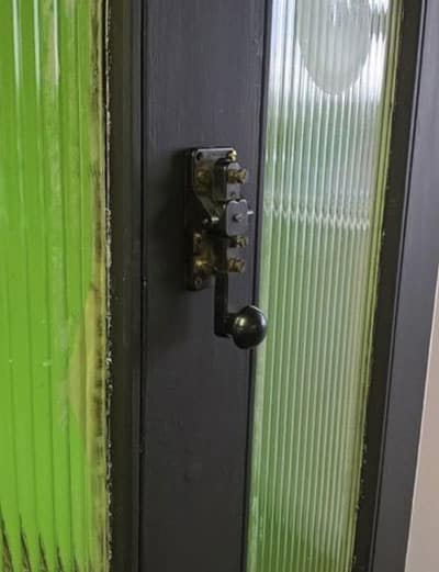Morse key mounted vertically on door as door knocker