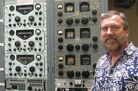 ZL1NZ with racks of Racal and Hammarlund receivers