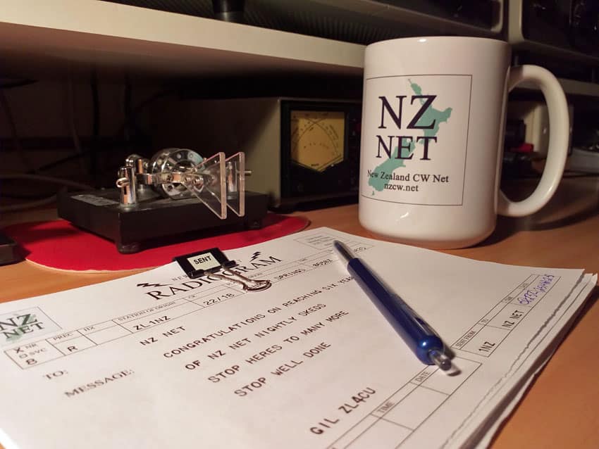NZ Net coffee mug on desk next to Bencher paddles and NZ Net message form