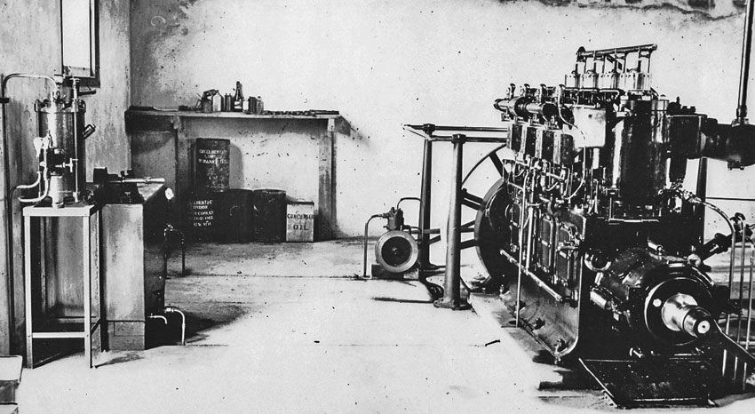 Photo of room with large engine, plus a couple of small benches