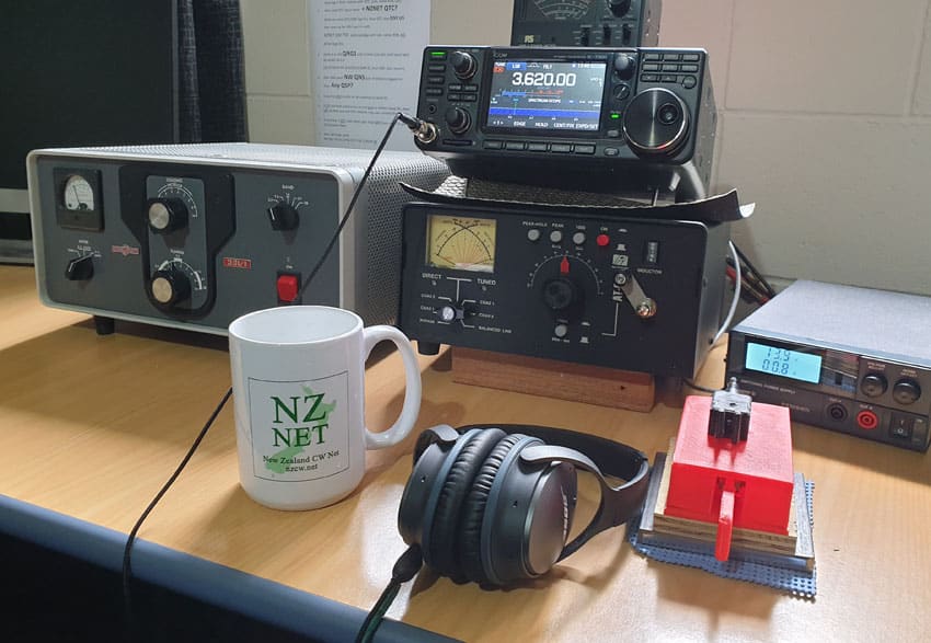 NZ Net mug next to 3D printed paddles at ZL4GW