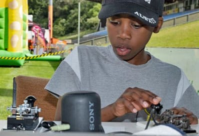 a young person with a morse key, photographed during Steel & Wheels 2025