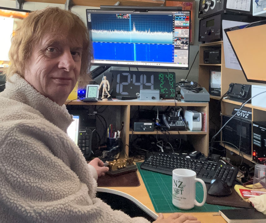 Chris G5VZ in his shack with NZ Net coffee mug