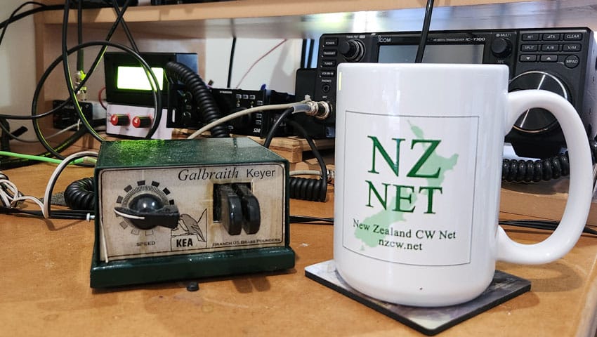 Galbraith KEA electronic keyer and an NZ Net coffee mug in front of an IC-7300 transceiver