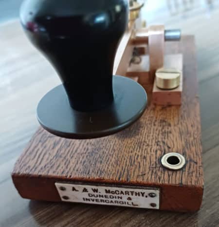 Close-up photo of the A and W McCarthy nameplate on a telegraph key