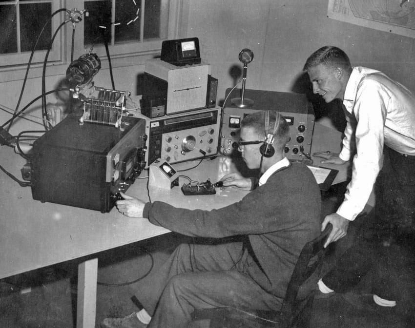 2 radio amateurs, probably at a club radio station in the 1960s