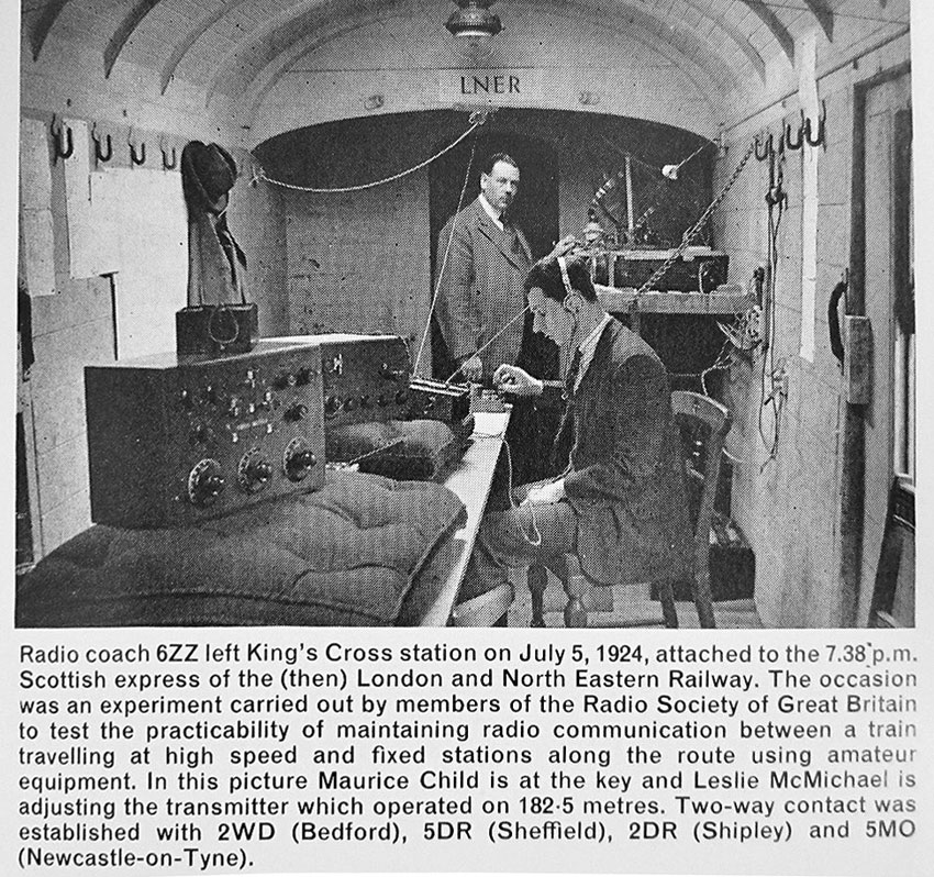 photo shows two men with radio equipment in an English train carriage, testing communications in 1924