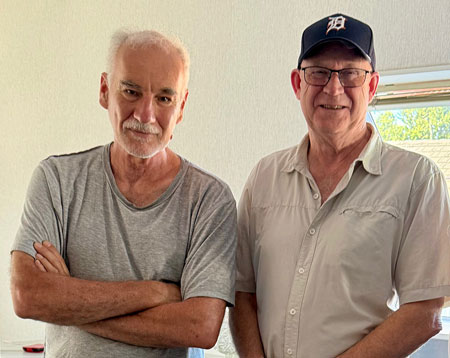 2 handsome men standing together