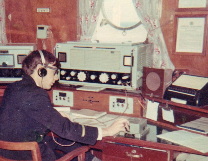 Young radio officer using straight key