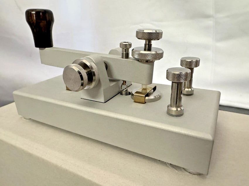 Morse key sitting on its box