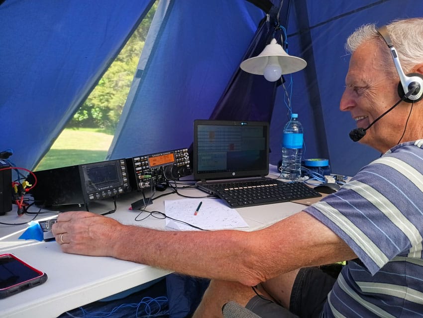radio operator ZL1AJY operating CW with a paddle key during Field Day