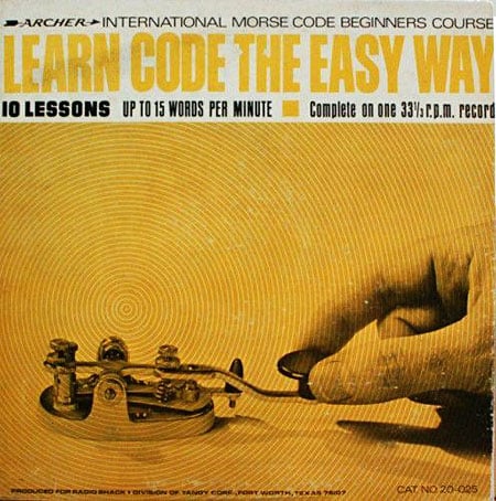 Record cover for Archer's Learn Code the Easy Way. features a person's hand on a simple Radio Shack key