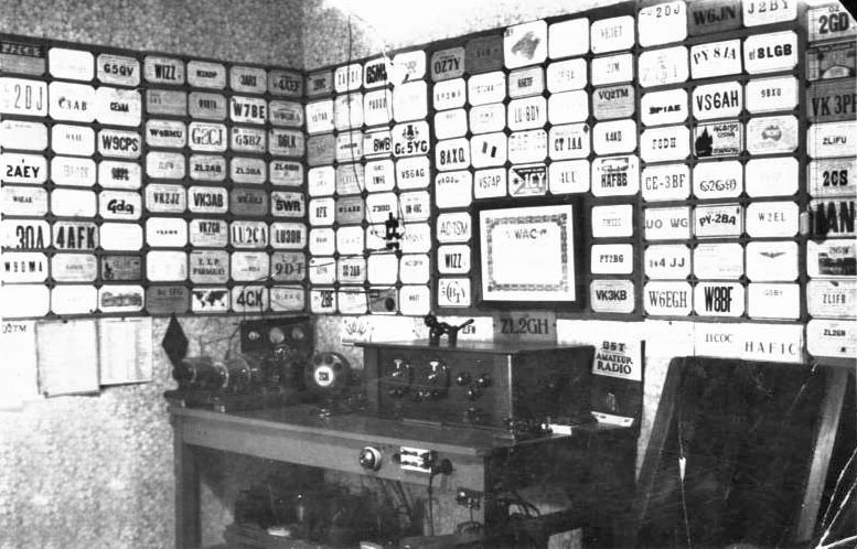 very neat amateur radio station with walls covered in QSL cards in 1930