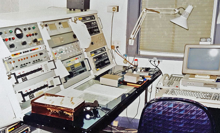Radio console with various receivers and controls for transmitters.