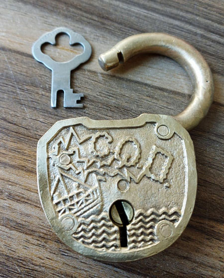 Front view of padlock with illustration of sinking ship sending the distress call CQD